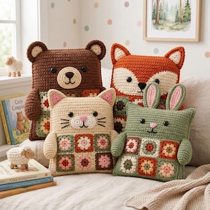 May include: Four square crochet pillows shaped like animals, including a brown bear, an orange fox, a beige cat, and a green rabbit. Each pillow features a base made of colorful floral granny squares, black button eyes, and embroidered facial details.