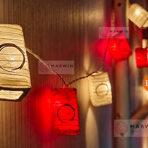 May include: String of lights with white and red paper lanterns. The lanterns have a circle design and are lit up. The text "Etsy" and "Marwin Craft" is visible in the image.