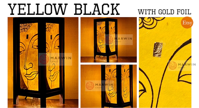May include: A yellow and black table lamp with a gold foil accent. The lamp features a Buddha face design and is made of wood. The lamp is lit and the light shines through the paper.