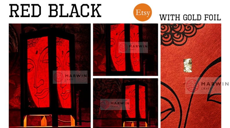 May include: A red and black wooden lamp with a gold foil accent. The lamp features a design of a Buddha face. The lamp is lit and the light shines through the paper. The lamp is on a wooden base. The lamp is handmade and is available on Etsy.