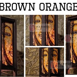 May include: A brown wooden lamp with a glass panel featuring a stylized orange and yellow face. The lamp has a square base and a rectangular shade. The lamp is lit and the face is illuminated. The lamp is labeled "Marwin" on the side.