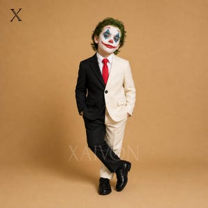 May include: A two-tone suit featuring a black left side and a cream right side, paired with a white dress shirt, a solid red necktie, and black dress shoes. The ensemble is worn by a child with green hair and clown-inspired face paint.