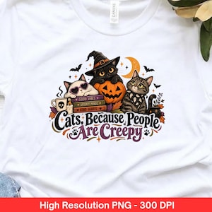 May include: A white t-shirt featuring a graphic of three cats, a pumpkin, books, and a coffee mug. The text reads, "Cats, Because People Are Creepy." The books are labelled "Good Vibes," "Spooky Minds," and "Kind Hearts." The design includes bats and a crescent moon.