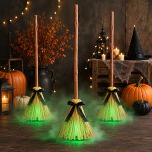 May include: Three upright decorative brooms with textured brown handles and light-colored bristles, each adorned with a black ribbon bow. The base of each broom emits a vibrant green light, creating a glowing effect amidst a light green mist.