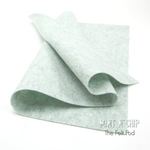 May include: A sheet of light green felt, folded in half, with a subtle speckled texture. The felt is labelled "Mint Chip" and "The Felt Pod".