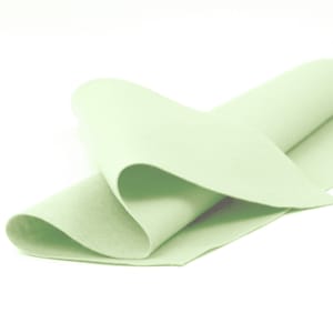 May include: A light green felt sheet folded in half. The felt is soft and smooth.