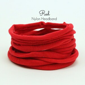May include: Red nylon headband. The headband is rolled up and is about 10 inches in diameter.