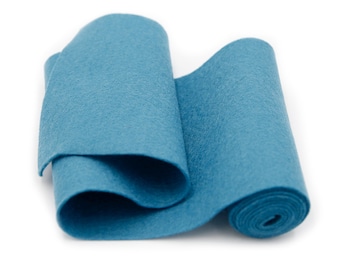 May include: A roll of teal blue felt fabric. The felt is rolled up and the end is visible.