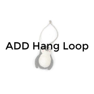 May include: A white felt penguin ornament with black wings and a loop of twine for hanging. The text "ADD Hang Loop" is visible in the image.
