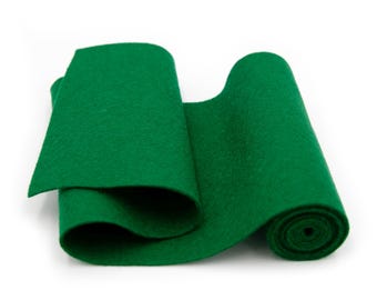 May include: A roll of green felt fabric. The felt is rolled up and the end is visible.