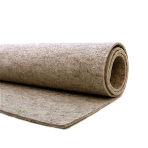 May include: A roll of beige felt fabric. The fabric is rolled up and the end is unfurled, showing the texture of the felt.