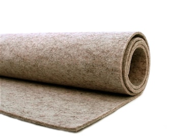May include: A roll of beige felt fabric. The fabric is rolled up and the end is unfurled, showing the texture of the felt.