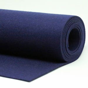 May include: A roll of dark blue felt fabric. The fabric is rolled up and the end is visible.