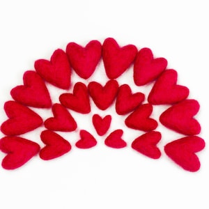 May include: A half-circle arrangement of felt hearts in various sizes, all in a vibrant red color. The hearts are arranged in a gradient pattern, with the largest hearts at the top and the smallest hearts at the bottom.