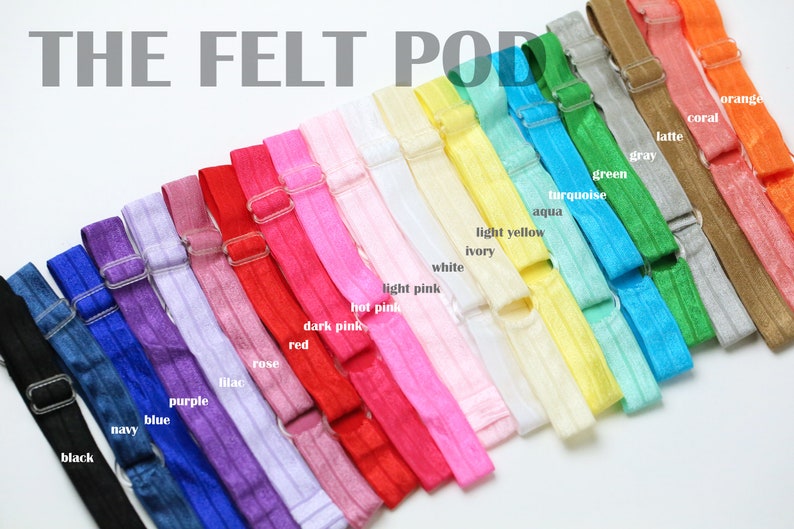 May include: A variety of colors of felt hair ties with a metal clasp. The colors include black, navy, blue, purple, lilac, rose, red, dark pink, hot pink, light pink, white, ivory, light yellow, aqua, turquoise, green, gray, latte, coral, and orange.