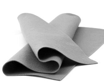 May include: A folded piece of gray felt fabric. The felt is smooth and has a soft texture.