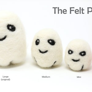 May include: The Felt Pod is a set of three white felt ghost ornaments with black embroidered faces. The ghosts are in three sizes: large, medium, and mini. A 2.5 inch pink felt ball is also included.