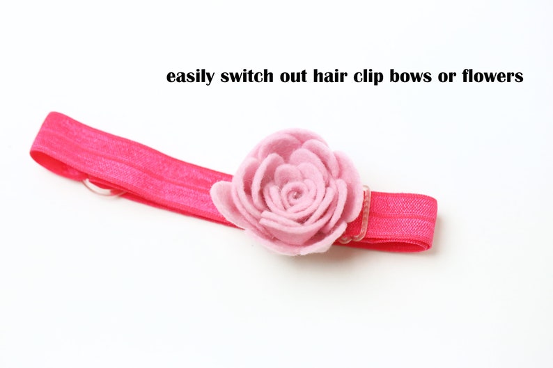 May include: A pink elastic headband with a pink felt flower attached. The headband is designed to easily switch out hair clip bows or flowers.
