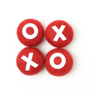 May include: Four red felt balls with white letters spelling out "XO XO".