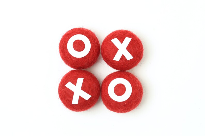 May include: Four red felt balls with white letters spelling out "XO XO".