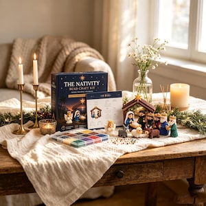 May include: A nativity bead craft kit box labelled The Nativity, featuring a set of small crocheted figures including an angel, a manger, and wise men. A clear plastic organiser filled with colourful beads sits next to the box and figures.