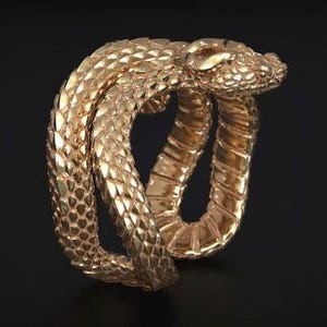 May include: A rose gold ring shaped like a coiled snake with detailed scales covering the exterior and a smooth underside. The snake head is positioned at the top of the coil. A small square logo with the text HM JEWELS HUB is in the corner.
