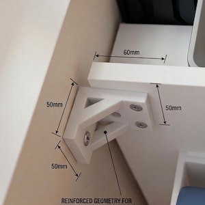 May include: A white triangular support bracket with reinforced geometry for vibration dampening, featuring visible screw heads. Technical annotations indicate dimensions of 50mm by 50mm by 60mm, with text stating: REINFORCED GEOMETRY FOR SUPERIOR VIBRATION DAMPENING.