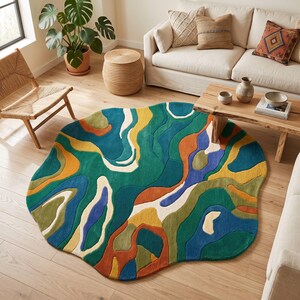 May include: An irregularly shaped area rug featuring a vibrant, abstract pattern of flowing, organic shapes in shades of deep teal, forest green, mustard yellow, burnt orange, royal blue, and cream, with a textured, tufted surface finish.