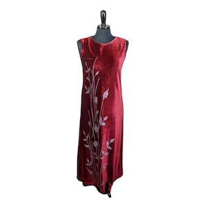 May include: A sleeveless burgundy velvet dress with a silver floral design.