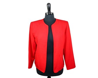 May include: A red blazer with a long sleeve and a collarless neckline. The blazer is on a black mannequin.
