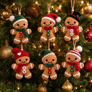 May include: Six crocheted gingerbread ornaments hanging from twine. Each figure has a tan body, black eyes, pink cheeks, and white icing details. They wear various accessories including knit hats, scarves, and bow ties in red, green, and white.