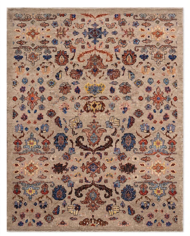 May include: A rectangular area rug featuring a light beige background with a repeating intricate pattern of floral and geometric motifs in shades of deep blue, rust orange, muted yellow, and dark brown, arranged in a symmetrical layout.
