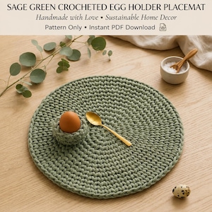 May include: A round sage green crocheted placemat featuring an integrated egg holder, a brown egg, and a gold spoon. The text SAGE GREEN CROCHETED EGG HOLDER PLACEMAT, Handmade with Love, Sustainable Home Decor, Pattern Only, Instant PDF Download is visible.