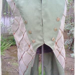 May include: A green and beige sleeveless vest with a high collar and gold buttons. The vest has a unique design with a rope pattern on the sides.