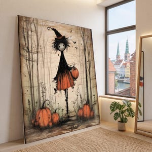 Może przedstawiać: Duży prostokątny wydruk ścienny przedstawiający fantazyjną ilustrację wysokiej, szczupłej postaci w spiczastym kapeluszu czarownicy i ciemnej sukni, stojącej w lesie z pomarańczowymi dyniami, nietoperzami i nagimi drzewami w stonowanej kolorystyce.