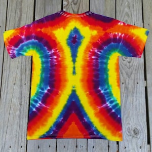 May include: A tie-dye t-shirt with a rainbow pattern. The shirt is made of a soft, comfortable material and features a unique, symmetrical design.
