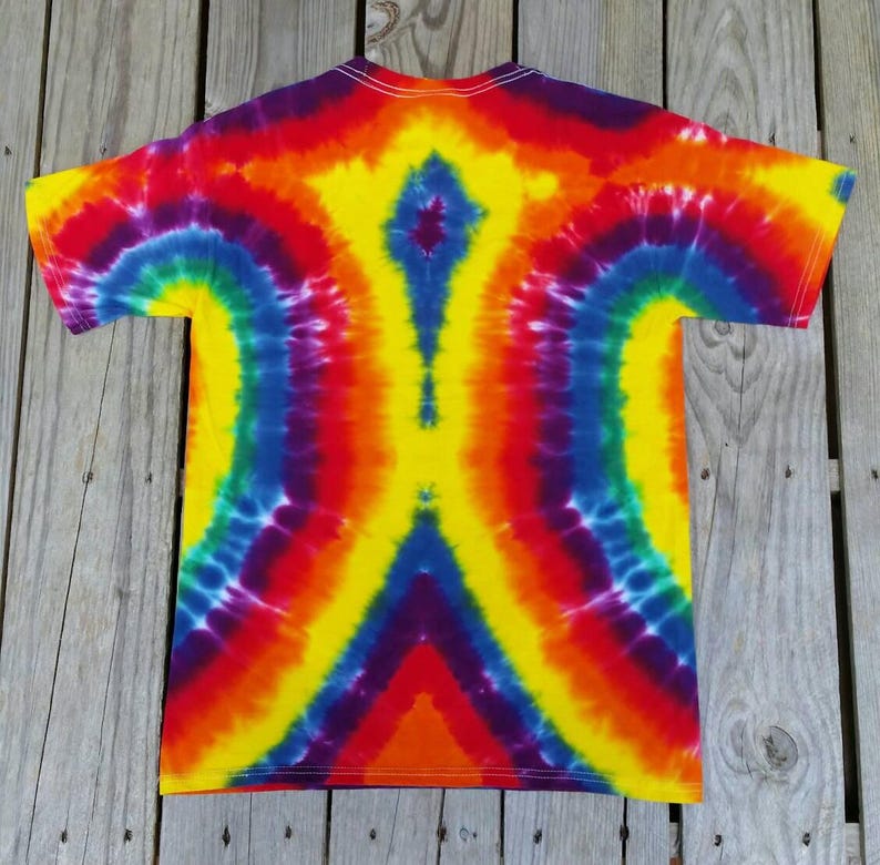 May include: A tie-dye t-shirt with a rainbow pattern. The shirt is made of a soft, comfortable material and features a unique, symmetrical design.