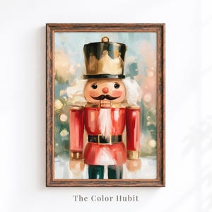 May include: A framed wall art print featuring a nutcracker figure with a black crown, red jacket, and white beard. The nutcracker stands against a soft, blurred background with bokeh lights. The text The Color Hubit is printed at the bottom.