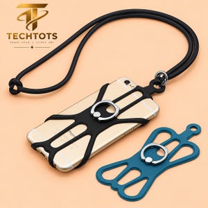 May include: A gold smartphone encased in a black silicone web-style holder with an integrated silver ring stand, attached to a long black neck lanyard. A separate teal silicone holder with a silver ring stand is positioned next to the phone.