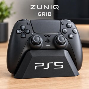 Könnte beinhalten: Ein mattschwarzer Gaming-Controller in einer schwarzen Ladestation mit dem in Weiß aufgedruckten Text PS5 auf der Vorderseite. Über dem Controller ist der Text ZUNIQ GRIB zu sehen. Der Controller verfügt über zwei Analogsticks, ein Steuerkreuz und vier Aktionstasten.