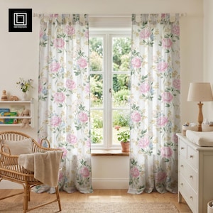 May include: White floral curtains with large pink peony blooms, blue accents, and green foliage. The curtains hang in front of a window, creating a soft, airy feel. The design is repeated across both panels, adding a touch of elegance to the room.