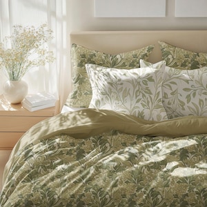 May include: A green and white floral patterned duvet cover with matching pillowcases. The duvet cover has a light brown underside.