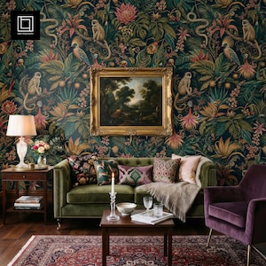 May include: A living room featuring a dark green velvet sofa, a purple armchair, and a patterned rug. The wall is adorned with jungle-themed wallpaper depicting monkeys, parrots, and dense foliage. A framed landscape painting is above the sofa.