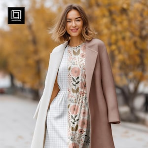 May include: A sleeveless dress featuring a split design with a white grid pattern on one side and a floral print with pink flowers and green leaves on the other, worn under a white coat on the left and a mauve coat on the right side.