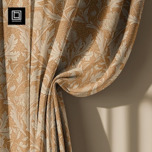 May include: Close-up of a tan and cream-colored curtain with a repeating floral pattern. The fabric is draped, showing the texture and folds of the material. The design features stylized leaves and flowers, creating a classic, elegant look. The curtain is against a neutral background.
