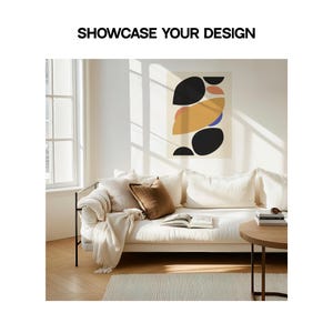 May include: A white couch with a brown throw blanket and a brown pillow. The couch is in front of a window with sunlight streaming in. A black and white abstract art print hangs on the wall behind the couch. The text "SHOWCASE YOUR DESIGN" is printed above the image.