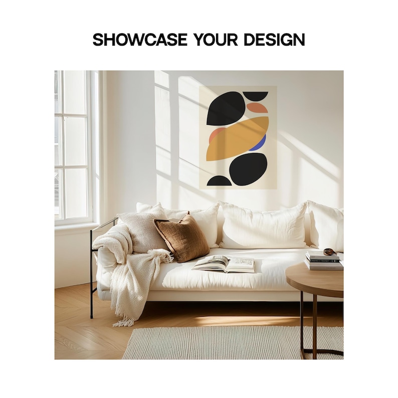 May include: A white couch with a brown throw blanket and a brown pillow. The couch is in front of a window with sunlight streaming in. A black and white abstract art print hangs on the wall behind the couch. The text "SHOWCASE YOUR DESIGN" is printed above the image.