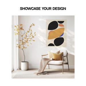May include: Abstract art print featuring a geometric design with black, yellow, orange, and blue shapes. The print is hanging on a white wall in a living room setting with a chair and a potted plant.