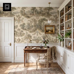 May include: A wooden desk with a chair, positioned against a wall covered in beige and brown toile wallpaper featuring landscape scenes. The room includes a white door, built-in white bookshelves, a framed painting, and a hanging pendant light.