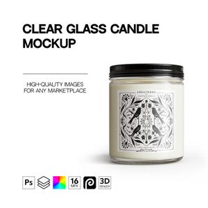 May include: A clear glass candle with a black lid and a white label. The label features a black and white design of birds and flowers. The text on the label reads "AREATHORS", "BHATME GEALE", and "LANS SEATS BURD".